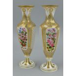 A PAIR OF LATE 19TH CENTURY CASED GLASS BALUSTER VASES, circular gilt rims over facet cut white