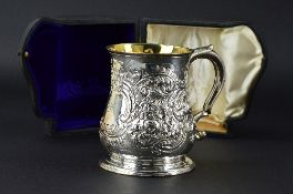 A GEORGE II SILVER TANKARD, of baluster form, the body later repousse decorated and chased with