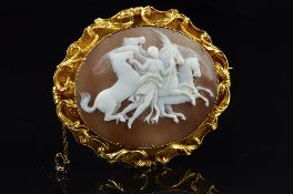 A LARGE OVAL SHELL CAMEO BROOCH, depicting 'Nike Conducting the Horses of The Sun' enclosed within a