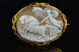 A LARGE OVAL SHELL CAMEO BROOCH, depicting a classical chariot scene, enclosed within a plain