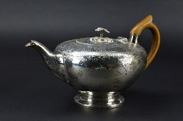A GEORGE III TEAPOT, of flattened bullet form, the finial cast as two flowers and leaves, the cover,