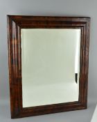 A WILLIAM & MARY STYLE WALNUT VENEERED CUSHION FRAMED MIRROR, bevel edged plate, plate size
