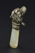 A LATE 19TH/EARLY 20TH CENTURY NOVELTY SILVER DOG'S HEAD RATTLE, lacks bells, mother of pearl