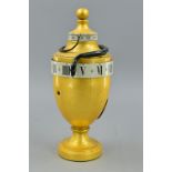 A 19TH CENTURY AND LATER MYSTERY CLOCK, in the form of a gilt urn, fitted with a minutes band in
