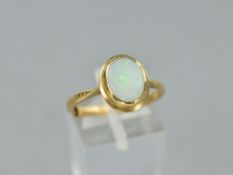 A LATE 20TH CENTURY SINGLE STONE OPAL RING, oval rub over set white opal measuring approximately