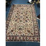 A LARGE WOOLLEN CARPET SQUARE, cream, blue, red ground and geometric detail, approximate size