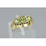 A 9CT PERIDOT AND DIAMOND RIN G, ring size M, approximate weight 2.4 grams