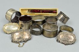 EIGHT MIXED SILVER NAPKIN RINGS, approximate weight 157 grams, three silver decanter labels, Sherry,