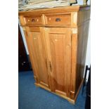 A PINE TWO DOOR CUPBOARD, with two drawers above, both door fold back to sides with a keyboard slide