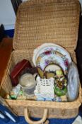 A SMALL WICKER BASKET CONTAINING VARIOUS CERAMICS AND SUNDRY ITEMS, to include German key holder