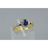 A LATE 20TH CENTURY 18CT GOLD SAPPHIRE AND DIAMOND OVAL CLUSTER RING, estimated total modern round