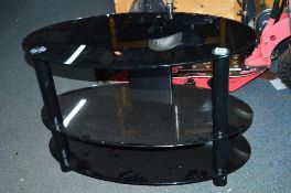 A BLACK GLASS OVAL TV STAND