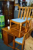 AN OAK DROP LEAF TABLE, with four chairs and a mahogany corner cupboard