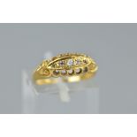 AN EARLY 20TH CENTURY 18CT GOLD DIAMOND HALF HOOP RING, boat setting, pierced gallery and scroll