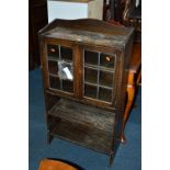 A LIBERTY OF LONDON GLAZED BOOKCASE, with two leaded glass doors over two open book shelves (liberty