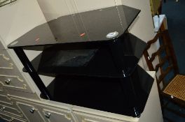 A THREE TIER BLACK GLASS TV STAND