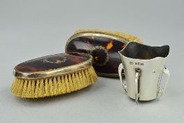 A PAIR OF TORTOISESHELL PIQUE CLOTHES BRUSHES, and a small silver four handled vase
