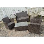 A GARDEN RATTAN FOUR PIECE SUITE, together with a matching coffee table (4)