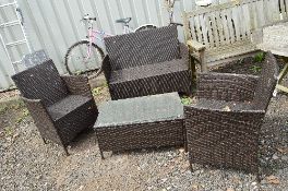 A GARDEN RATTAN FOUR PIECE SUITE, together with a matching coffee table (4)
