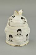 A FINE BONE CHINA 'BEEHIVE' HONEY POT, depicting the faces of 'The Beatles', approximate height