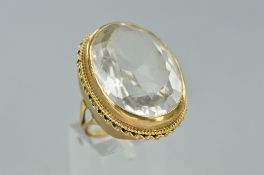 A LATE 20TH CENTURY LARGE SINGLE STONE QUARTZ RING, a large oval mixed cut rock crystal measuring