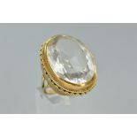 A LATE 20TH CENTURY LARGE SINGLE STONE QUARTZ RING, a large oval mixed cut rock crystal measuring