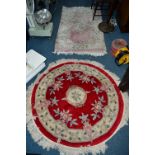 A CIRCULAR CHINESE WOOLLEN RUG, two other chinese rugs and a modern carpet square (4)