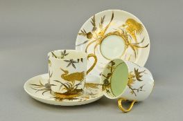 TWO ROYAL WORCESTER CUPS AND SAUCERS, gilt decorated with chinoiserie crane on cream ground (one