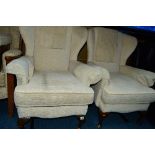 A PAIR OF OATMEAL UPHOLSTERED WINGBACK ARMCHAIRS