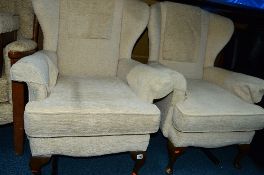 A PAIR OF OATMEAL UPHOLSTERED WINGBACK ARMCHAIRS