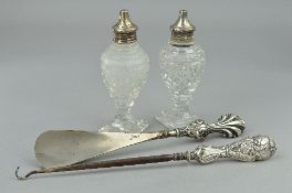 A SILVER SALT AND PEPPER, a silver button hook and a shoe horn (4)