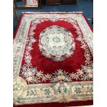 A LARGE CHINESE WOOLLEN CARPET SQUARE, red and cream ground, floral design, approximate size 370cm x