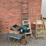 A BISTRO TABLE, four sets of step ladders, a wheel barrow and other items