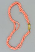 A CORAL TRIPLE ROW TWIST NECKLACE, pale pink coral beads, each round bead measuring approximately