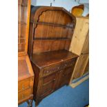 AN OAK DRESSER, with arched plate rack and linenfold detail to base