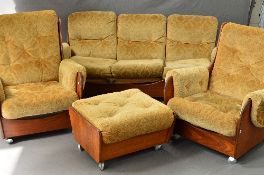 A G-PLAN TEAK FOUR PIECE SADDLE LOUNGE SUITE, with gold upholstery, Pirelli padding on orbit