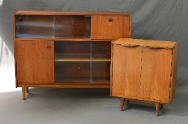 A NATHAN TEAK BOOKCASE IN THE STYLE OF ROBERT HERITAGE, with two tiered glazed sliding doors, fall
