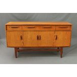 A G-PLAN FRESCO TEAK SIDEBOARD, flanked by two short and one long drawer above four doors,