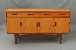 A G-PLAN FRESCO TEAK SIDEBOARD, flanked by two short and one long drawer above four doors,