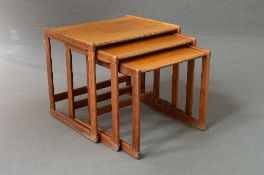 A TEAK NEST OF THREE TABLES, with a stretched base, approximate size of largest table width 54.5cm x