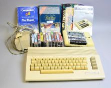 A COMMODORE 64 VINTAGE PERSONAL COMPUTER, with Datassette, PSU, fourteen games and manuals