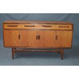 A G-PLAN FRESCO TEAK SIDEBOARD, flanked by four drawers above four cupboard doors, approximate