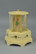 A BAKELITE NOVELTY SELCO MUSICAL CIGARETTE DISPENSER, the compartments decorated with ladies, the