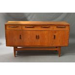 A G-PLAN FRESCO TEAK SIDEBOARD, flanked by two short drawers, one long drawer and four cupboard