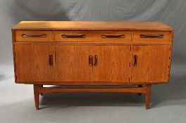 A G-PLAN FRESCO TEAK SIDEBOARD, flanked by two short drawers, one long drawer and four cupboard
