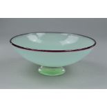 NEIL WILKIN, AN EARLY STUDIO ART GLASS BOWL, with pale green body topped with a burgandy red rim