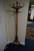 A 20TH CENTURY WALNUT BENTWOOD STYLE WALL STANDING SINGLE SIDED HAT STAND, approximate height 199cm