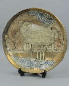 A STUDIO POTTERY CHARGER, with indistinct makers mark impressed into the base, decorated with