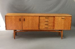 A G-PLAN TEAK SCANDINAVIAN SIDEBOARD, designed by W.B. Wilkins, flanked by four drawers, double
