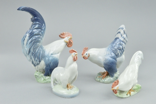 TWO PAIRS OF ROYAL COPENHAGEN COCKERELS AND HENS, designed by Christian Thomsen, model numbers 1024,